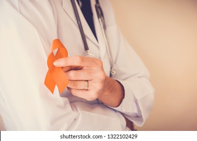 Doctor Holding Orange Ribbon, Leukemia Cancer Awareness And Multiple Sclerosis And ADHD , COPD Awareness, World Kidney Day