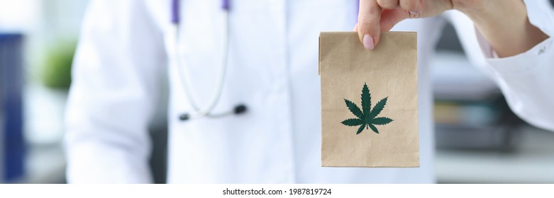 Doctor Holding Package With Marijuana In Clinic Closeup