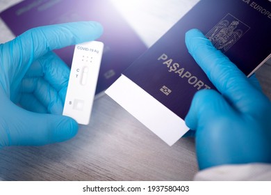 Doctor holding passport and negative covid-19 ( rapid antigen SARS-CoV-2 Ag ) test. Coronavirus and safety travel concept. - Shutterstock ID 1937580403