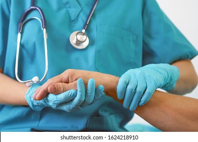 Doctor Holding Patient Hand, Examination Of Patients In The Hospital. Surgeon, Surgical Doctor, Anesthetist Holding Hand Patient. Professional Surgery, Therapy, Medical Recovery Concept.