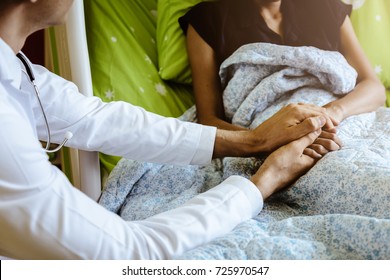 Doctor holding patient's hand, helping hand concept  and comforting her - Shutterstock ID 725970547
