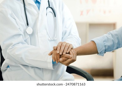 doctor holding a patient's hands to comfort and reassure them during a medical checkup at the hospital. Respect, help, trust, support in healthcare, holding hands for Comfort and encouragement. - Powered by Shutterstock