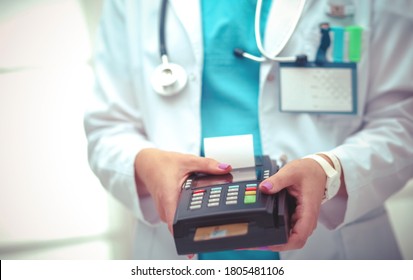 Doctor Is Holding Payment Terminal In Hands. Paying For Health Care. Doctor