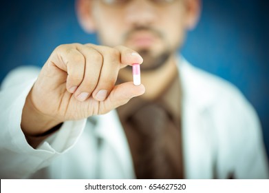 Doctor Holding A Pill Of Medicine