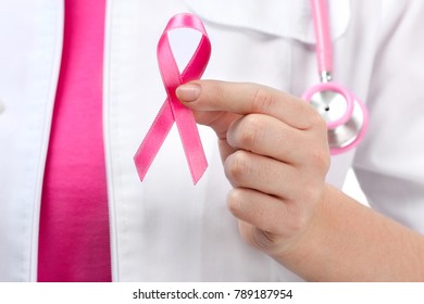 Doctor holding pink ribbon, closeup. Breast cancer awareness concept - Shutterstock ID 789187954