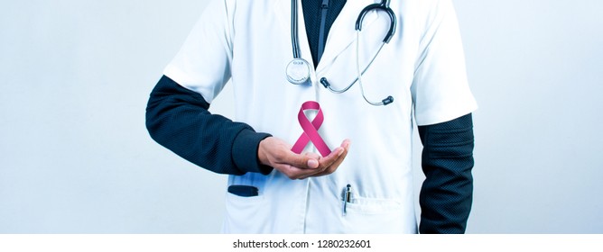 Doctor Holding Pink Ribbon With Stethoscope, World Cancer Day Concept Image,  2020 Cancer Day 