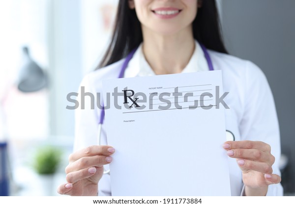 Doctor is holding prescription form for\
medicines. Prescription drug\
concept