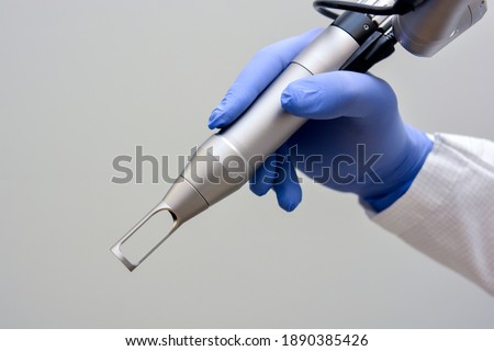 Doctor Holding Q-Switched Nd:YAG Laser Hand Piece