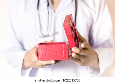 Doctor Holding The Red Gift Box In His Hand