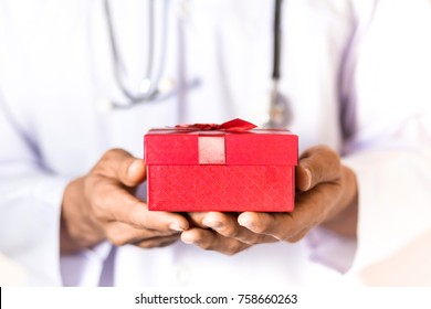 Doctor Holding The Red Gift Box In His Hand