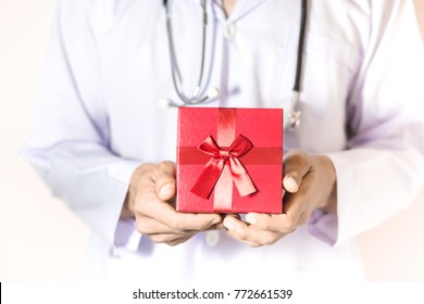 Doctor Holding The Red Gift Box In His Hand