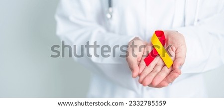 Doctor holding Red and Yellow ribbon. World hepatitis day awareness month, 28 July, Liver cancer, Jaundice, Cirrhosis, Failure, Enlarged, Hepatic Encephalopathy and Health concept