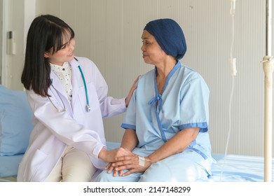 Doctor Holding Senior Cancer Patient's Hand In Hospital, Health Care And Medical Concept	
