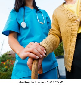 Doctor Holding A Senior Patients 's Hand On A Walking Stick - Special Medical Care Concept For Alzheimer 's Syndrome.