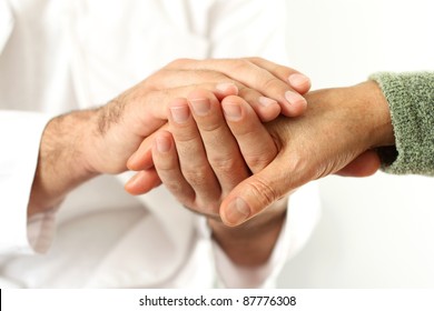 Doctor holding senior's hands