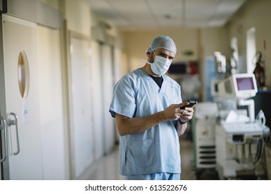 Doctor Holding Smartphone In The Passageway