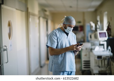 Doctor Holding Smartphone In The Passageway