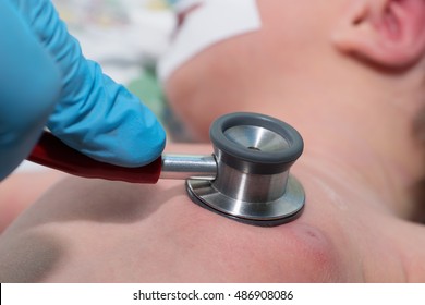 Doctor Holding Stethoscope In His Hand And Doing Auscultation Newborn Baby On Breathing Machine (mechanical Ventilator) In Neonatal Intensive Care Unit