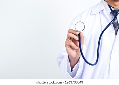 Doctor holding stethoscope on white background. Asian male model , Concept Cosmetic Surgery