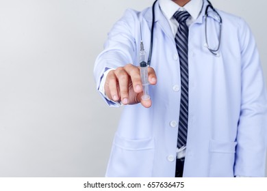 doctor holding syringe with injection on white background - Shutterstock ID 657636475