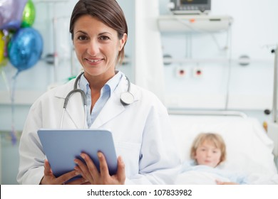 Doctor holding a tablet computer next to a child in hospital ward - Powered by Shutterstock