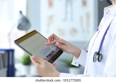 Doctor is holding tablet with heart cardiogram. Examination of cardiovascular system concept - Shutterstock ID 1911773305