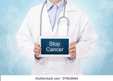 Doctor holding a tablet pc with stop cancer sign on blue background - Powered by Shutterstock