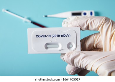 Doctor holding a test kit for viral disease COVID-19 2019-nCoV. Lab card kit test for viral novel coronavirus sars-cov-2 virus