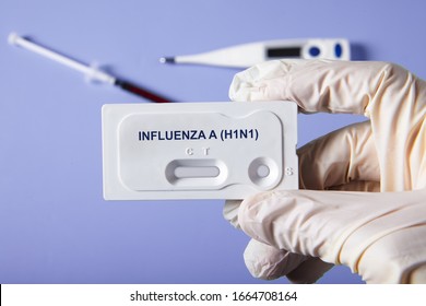 Doctor Holding A Test Kit For Viral Disease Influenza H1N1 Flu. Lab Card Kit Test For Flu Seasonal Type A Virus