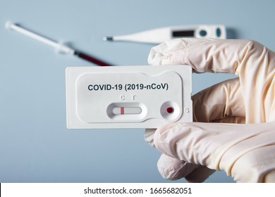Doctor holding a test kit for viral disease COVID-19 2019-nCoV. Lab card kit tested NEGATIVE for viral novel coronavirus sars-cov-2 virus 