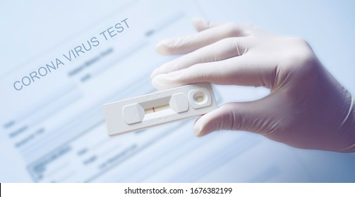 Doctor holding a test kit for viral disease COVID-19 2019-nCoV. Lab card kit test for viral novel coronavirus. Negative test result by using rapid test device for COVID-19.