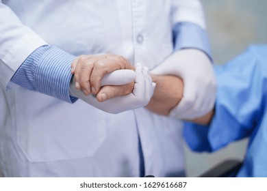 Doctor Holding Touching Hands Asian Senior Or Elderly Old Lady Woman Patient With Love, Care, Helping, Encourage And Empathy At Nursing Hospital Ward : Healthy Strong Medical Concept 
