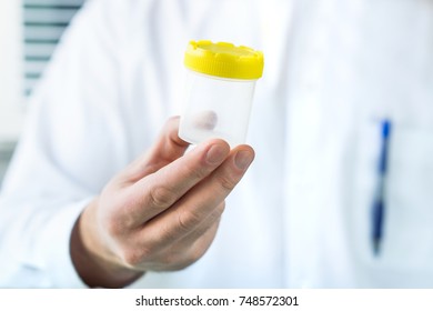 Doctor Holding Urine Sample Cup. Medical Test In Hospital.