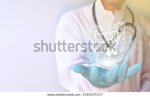 Doctor holding a virtual Intestine.\
Human organ drawn by hand, healthcare hospital service concept,\
nursing assistant, laboratory research and\
development.