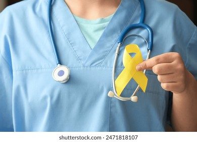 Doctor holding yellow ribbon, closeup. Sarcoma concept. - Powered by Shutterstock