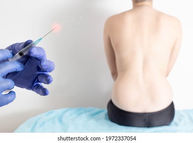 The Doctor Holds In His Hands A Syringe With Anti-inflammatory And Analgesic Medicine For Back Pain. Facet Joint Injection Therapy Concept, Medicinal Product