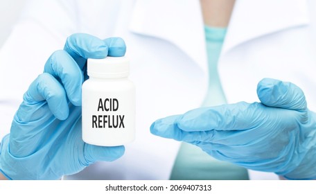 Doctor Holds A Jar Of The Diagnosis Acid Reflux. Selective Focus. Medical Concept.