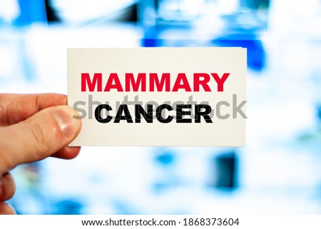 The doctor holds a paper with the patient's complex diagnosis MAMMARY CANCER.