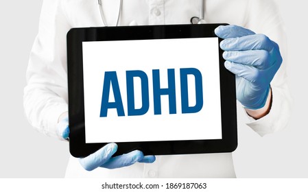 Doctor In Holds A Tablet With Text ADHD