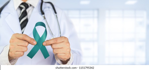 Doctor Holds Teal Green Ribbon Awareness In Hand,  
Campaigns Against Ovarian Cancer And Cervical Cancer.