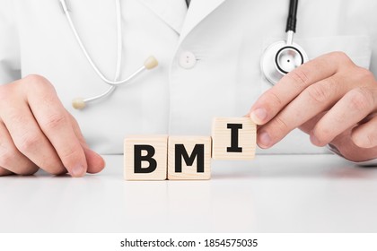 Doctor Holds Wooden Cubes In His Hands With Text BMI