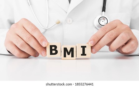 Doctor Holds Wooden Cubes In His Hands With Text BMI