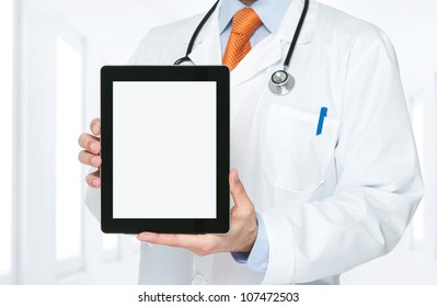 Doctor At Hospital Holding Blank Digital Tablet With Clipping Path For The Screen