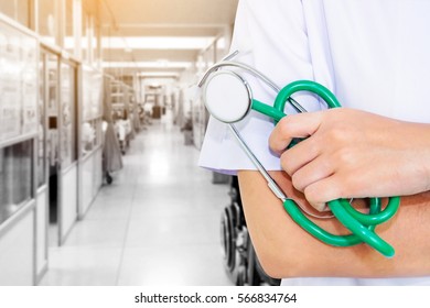 Doctor In Hospital Interior With White Uniform And Green Stethoscope And Hands And Free Space For You.