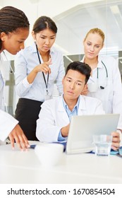 Doctor And Hospital Staff Work Together With Tablet Computer