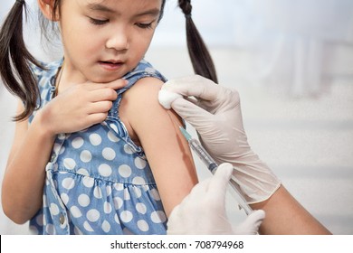 Doctor Injecting Vaccination In Arm Of Asian Little Child Girl,healthy And Medical Concept