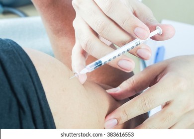 Doctor Injecting Vaccine To Patient Close Up Shot