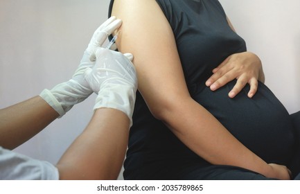 doctor injects vaccine into pregnant woman - Powered by Shutterstock