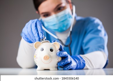 Doctor Inspecting Piggy Bank With Stethoscope, Economy Recession Due To Global COVID-19 Coronavirus World Pandemic Outbreak,financial Hardship & Uncertain Future,health Care,life Savings & Insurance