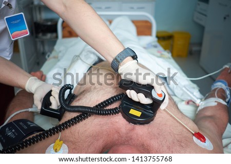 Doctor intensivist performs synchronized cardioversion to patient with AF